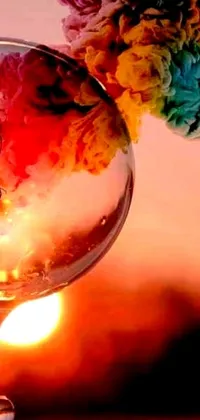This stunning phone live wallpaper features a colorful close up of a wine glass filled with beautiful flowers and set against a romantic album cover
