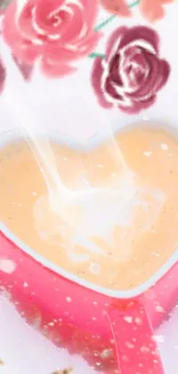 This phone live wallpaper features a heart-shaped, digital rendering of a cup of coffee