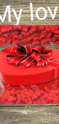 InThe new love seasons, decorate your phone screen with this beautiful live wallpaper featuring a red gift box on a wooden table