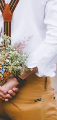 This phone live wallpaper features a stunning close-up of a person holding a vibrant bouquet of flowers, complete with blue and yellow ribbons