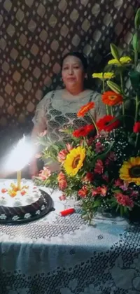 This live phone wallpaper features a woman enjoying a birthday cake with lit candle in a sunny setting
