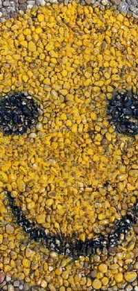 This cheerful live wallpaper features a yellow smiley face painted on the ground, surrounded by a mosaic of realistic smiling faces