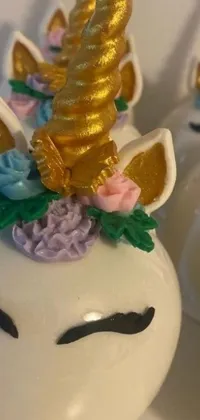 This live wallpaper depicts a mouth-watering cake adorned with a charming unicorn figurine