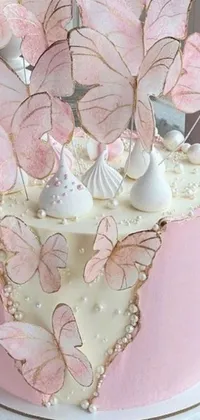 This phone live wallpaper features a freshly baked and frosted cake adorned with delicate butterflies on top