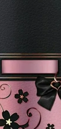 This phone live wallpaper showcases a stunning design featuring a blend of pink and black hues with floral elements and a cute bow