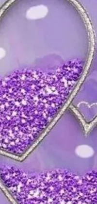 This phone live wallpaper features a digital art of purple hearts surrounded by a glitter effect and displaying various emoji faces