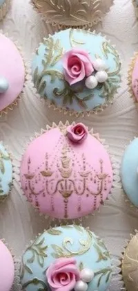 Indulge your sweet tooth with this charming live wallpaper featuring delectable cupcakes in pink and blue frosting