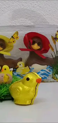 This vibrant phone live wallpaper depicts a colorful group of toys arranged on a table as a fully chocolate, detailed duck adorns the background
