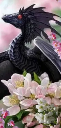 This phone live wallpaper features an intriguing image of a black bird seated atop a bundle of beautiful flowers