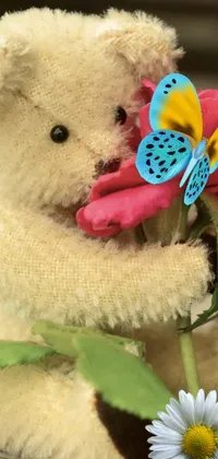 This lively phone wallpaper features an adorable teddy bear holding a colorful flower, with a butterfly perched on top