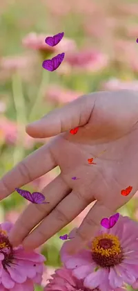 This phone live wallpaper showcases the exquisite beauty of a close-up shot of a hand touching a lovely flower