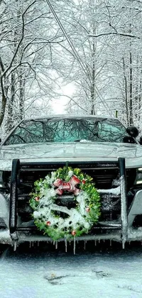 This dynamic live phone wallpaper features a police car with a wreath and flashing emergency lights atop a snowy forest scene with falling snowflakes
