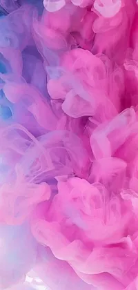 The phone live wallpaper showcases a mesmerizing close up of a swirling pink and blue substance set against a textured white and pink cloth background