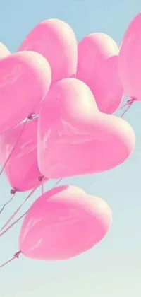 This live wallpaper features a delightful design of pink heart-shaped balloons floating in the air against a charming backdrop