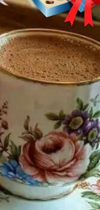 This live wallpaper for your phone features a beautiful painting of a cup of coffee on a saucer in photorealistic art nouveau style