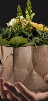 This charming live phone wallpaper features a rustic brown paper bag holding a bouqet of gorgeous flowers