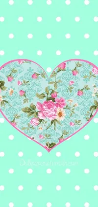 This phone live wallpaper features a gorgeous heart design with intricate pink flowers and foliage set against a lively polka dot background