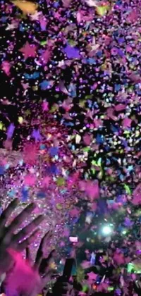 This lively phone live wallpaper features a colorful and joyful crowd of people throwing confetti in the air, set against a serene picture background