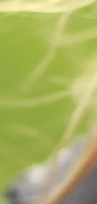 This phone live wallpaper showcases a blurry image of a person gripping a tennis racquet, with captivating video art in soothing leaf green shades