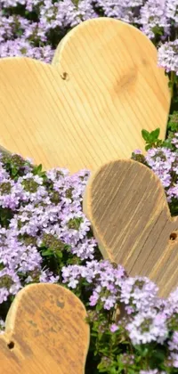 This phone live wallpaper showcases wooden hearts and purple flowers