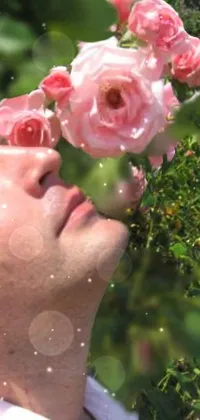 This live wallpaper for phones features a sophisticated scene of a man holding a bouquet of pink roses and inhaling their sweet fragrance