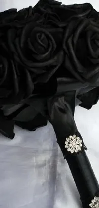 This live wallpaper features a beautiful bouquet of black roses against a pristine white background