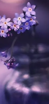 This live wallpaper features a delicate vase filled with beautiful purple flowers
