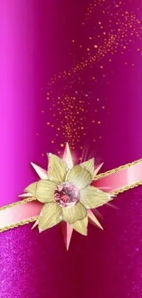 This stunning phone live wallpaper is a work of digital art, featuring a close up of a ribbon adorned with a beautiful pink flower and shimmering gold details