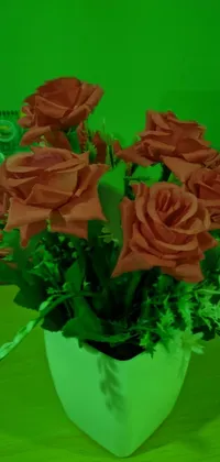 Enhance your phone's beauty with this stunning live wallpaper featuring a vase filled with red roses and placed on a table
