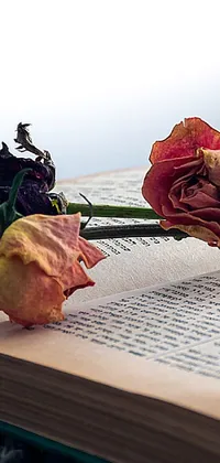 Get this stunning still life phone live wallpaper featuring two roses resting on an open book