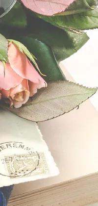 This stunning phone live wallpaper features beautiful pink roses atop a book, exuding a feeling of romanticism