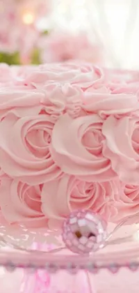 This pink cake live wallpaper features a gorgeous dessert on a glass cake plate with a rose background