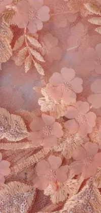 This phone live wallpaper features a close up of a beautiful dress with peach embellishment and intricate embroidery