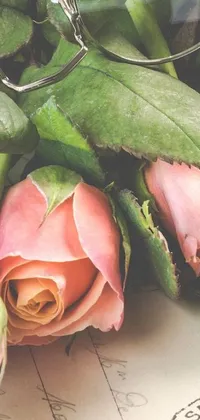 Enhance your phone's aesthetic appeal with this stunning live wallpaper featuring a captivating arrangement of delicate pink roses next to a pair of elegant glasses