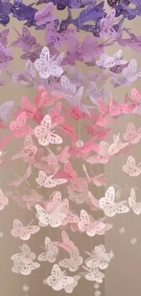 This phone live wallpaper showcases a beautiful scene of paper butterflies hanging from a ceiling in soft lilac skies