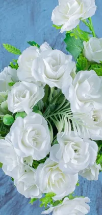 This phone live wallpaper showcases a beautiful vase with white flowers and ferns on a blue background