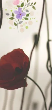This phone live wallpaper showcases a stunning close-up of a red flower in a vase, presented as a dreamy and blurry illustration connected to nature via vines, poppies, and symbols of historical importance