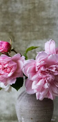 This stunning phone live wallpaper depicts a vase filled with gorgeous pink flowers on a wooden table