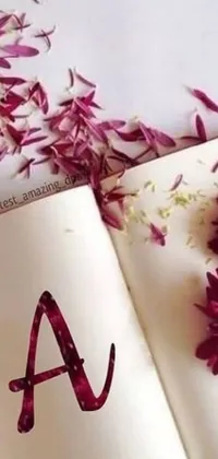 This live wallpaper showcases an open book positioned atop a table, complete with a single flower