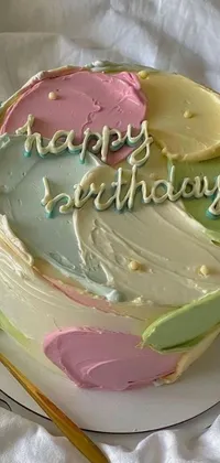 This live phone wallpaper features a stunning and elaborate birthday cake sitting on a white plate