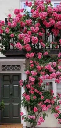 This phone live wallpaper features a delightful pink floral house with a green door, inspired by romanticism and nature