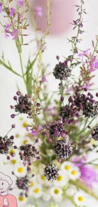 This phone live wallpaper features a vase filled with purple and white wildflowers including verbena, heather and irises