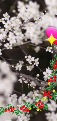 This live wallpaper features a heart-shaped balloon sitting atop a lush green tree