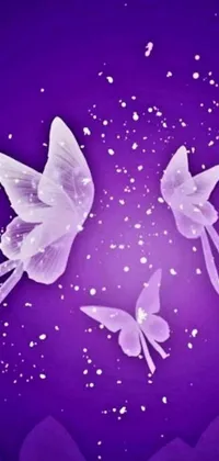 This phone live wallpaper features sparkling digital art of two white birds perched on a purple surface with glass wings and glowing butterflies
