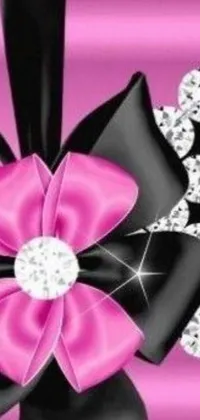 This beautiful phone live wallpaper showcases a close-up view of a stunningly tied bow featuring black gems and a pink background