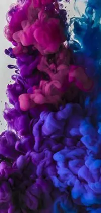 Indulge in a stunning animated wallpaper showcasing a captivating purple and blue substance swirling in water