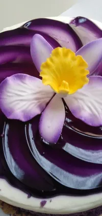 This phone live wallpaper features a stunning purple and white cake with a flower on top