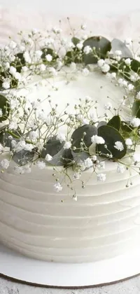 This beautiful phone live wallpaper features a stunning white cake topped with delicate baby's breath and surrounded by eucalyptus leaves
