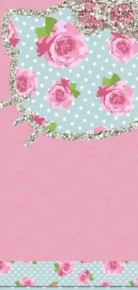 This smartphone live wallpaper features a delightful teapot with a vintage design adorned with roses and polka dots on a soft pink background