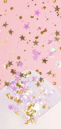 This phone live wallpaper features a charming scene of confetti falling out of an envelope against a warm, pink background